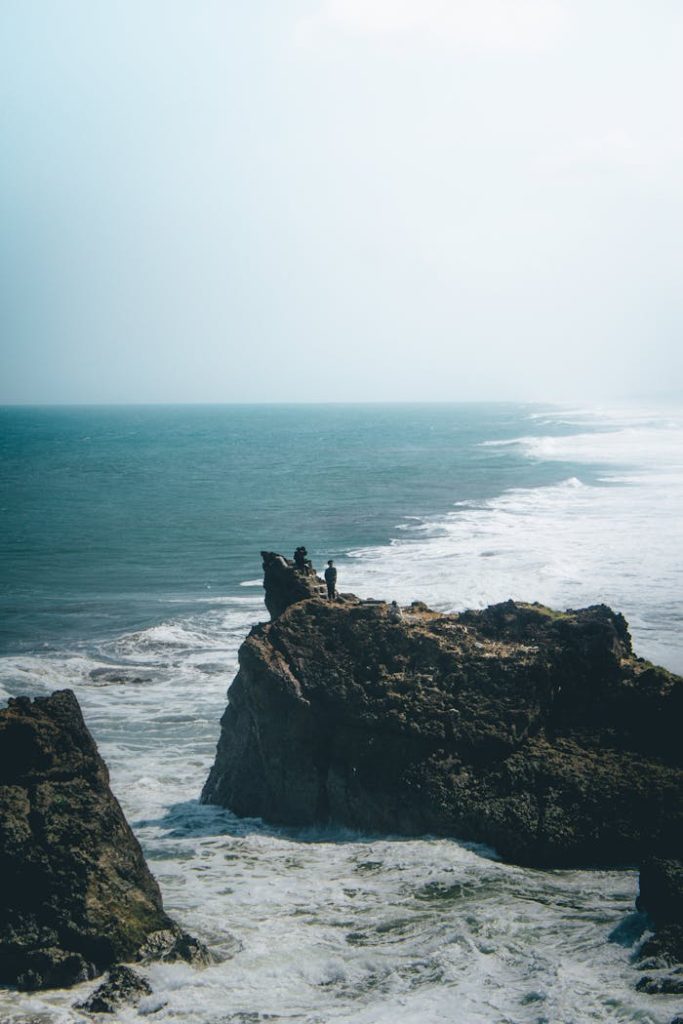 Majestic rocky cliff over a turquoise sea at Tasikmalaya, West Java, Indonesia, showcasing stunning natural beauty.